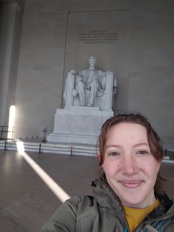 A woman (eryn) taking a selfie at the Abraham Lincoln monument.